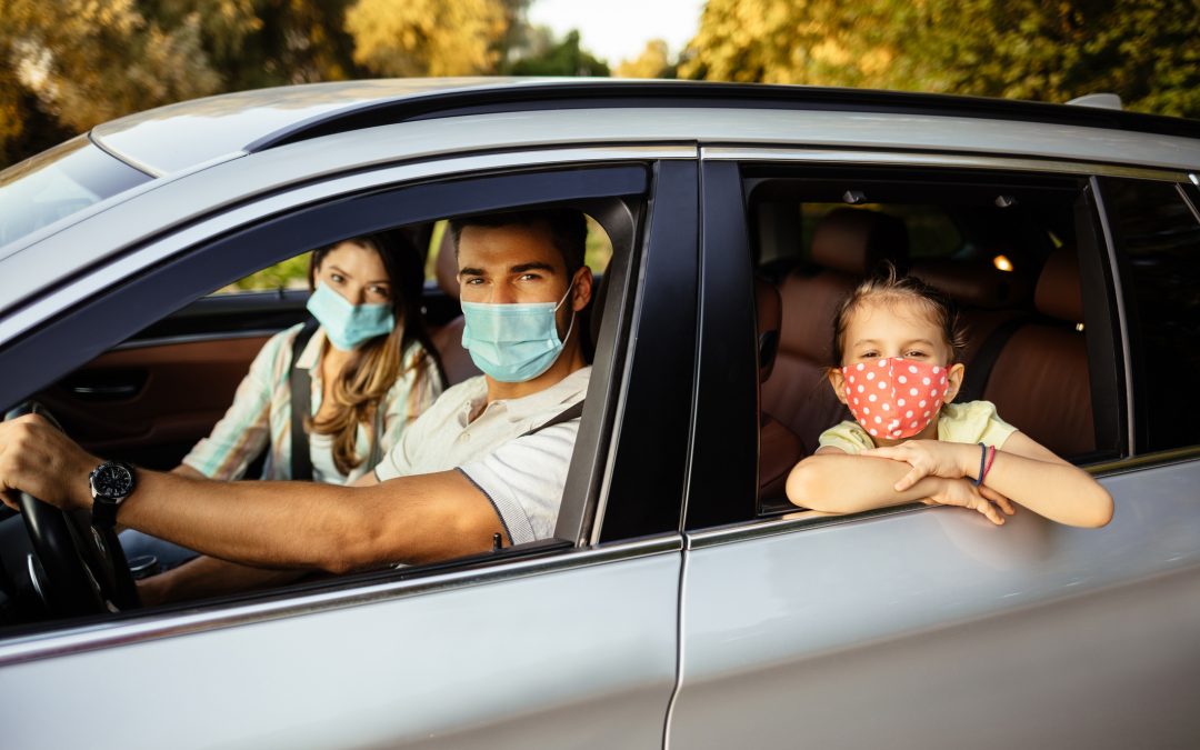 Family taking safety precautions to protect themselves while traveling with a car